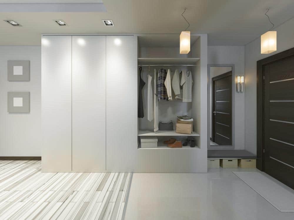 Modern coat wardrobe for hallway with multiple hanging rails and storage compartments in white finish