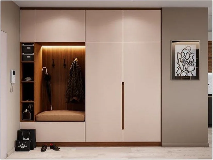Modern entrance hall wardrobe featuring coat hanging rail and shoe storage in white oak finish