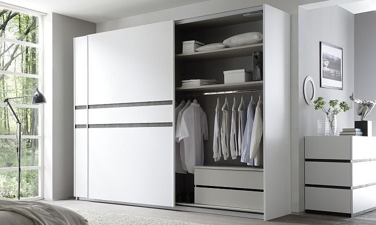 A modern wardrobe from BoxenSpace, showcasing dedicated hanging space for shirts, trousers, and dresses.
