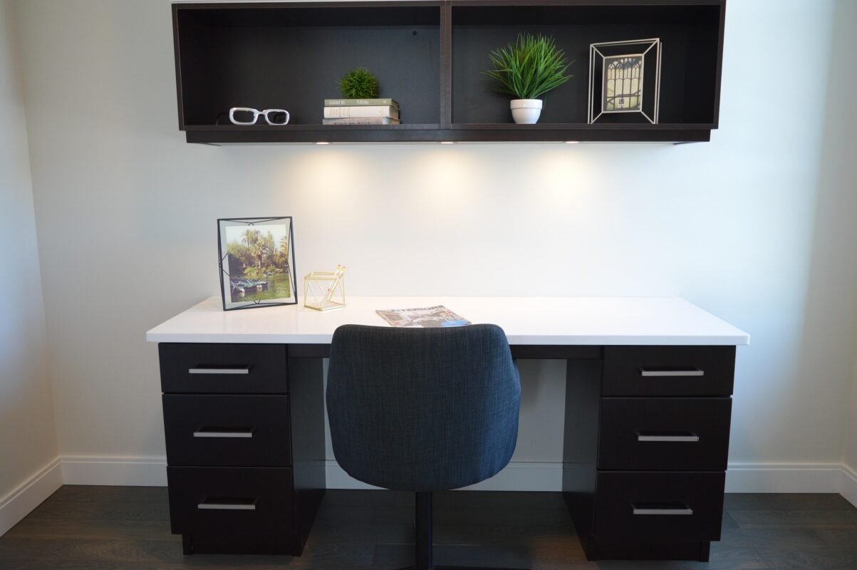 Modern black desk with slim legs and rear cable slot for a tidy UK home office