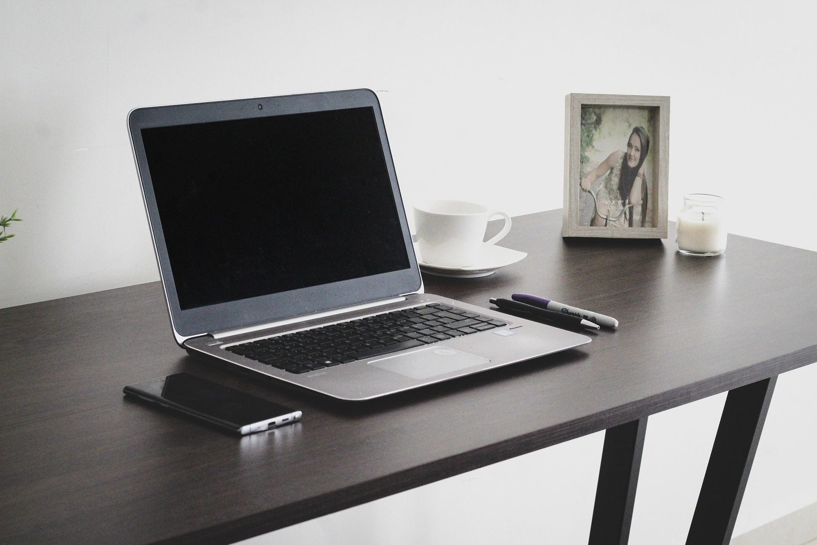 Sleek black desk with storage drawers and spacious top for a laptop and monitor