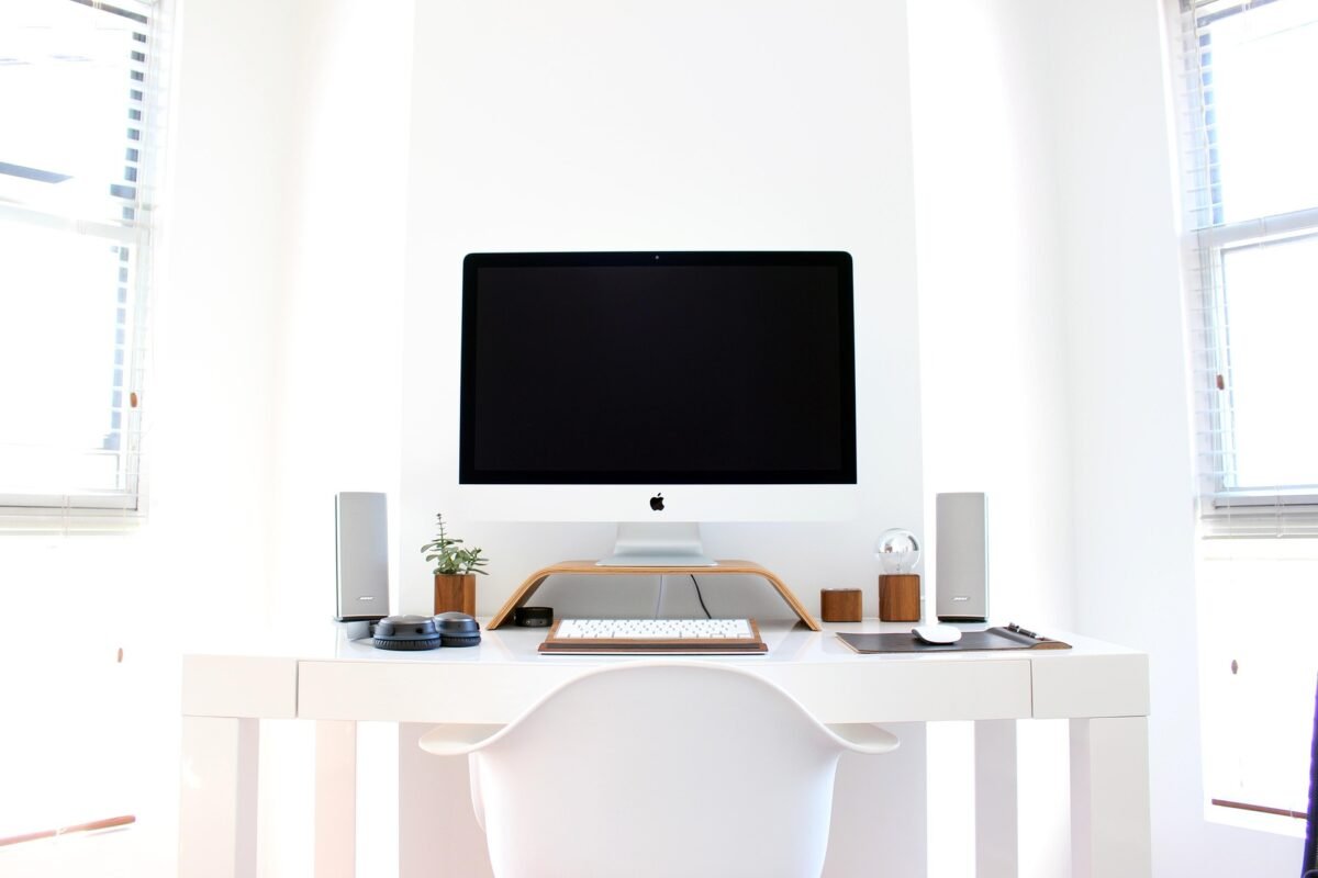 Modern white desk with three drawers and cable port for a tidy UK home office