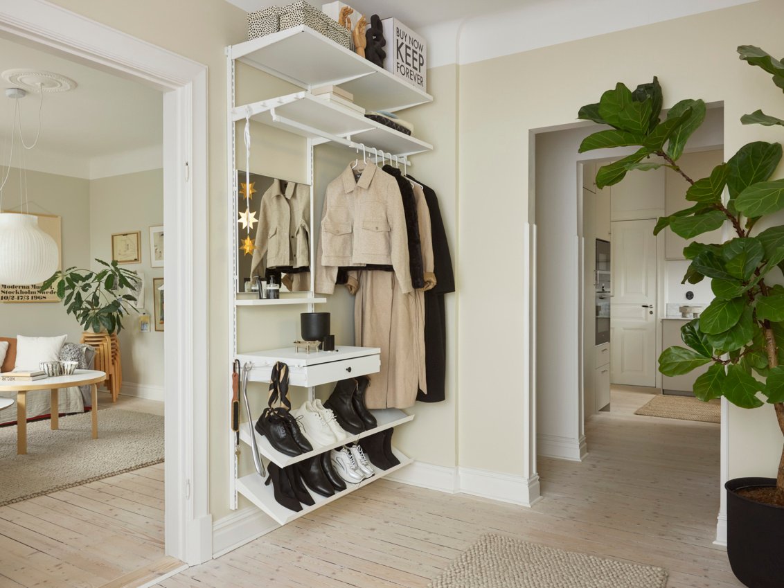 Modern slim hallway wardrobe featuring coat rail and shoe compartments in white finish for narrow hallways