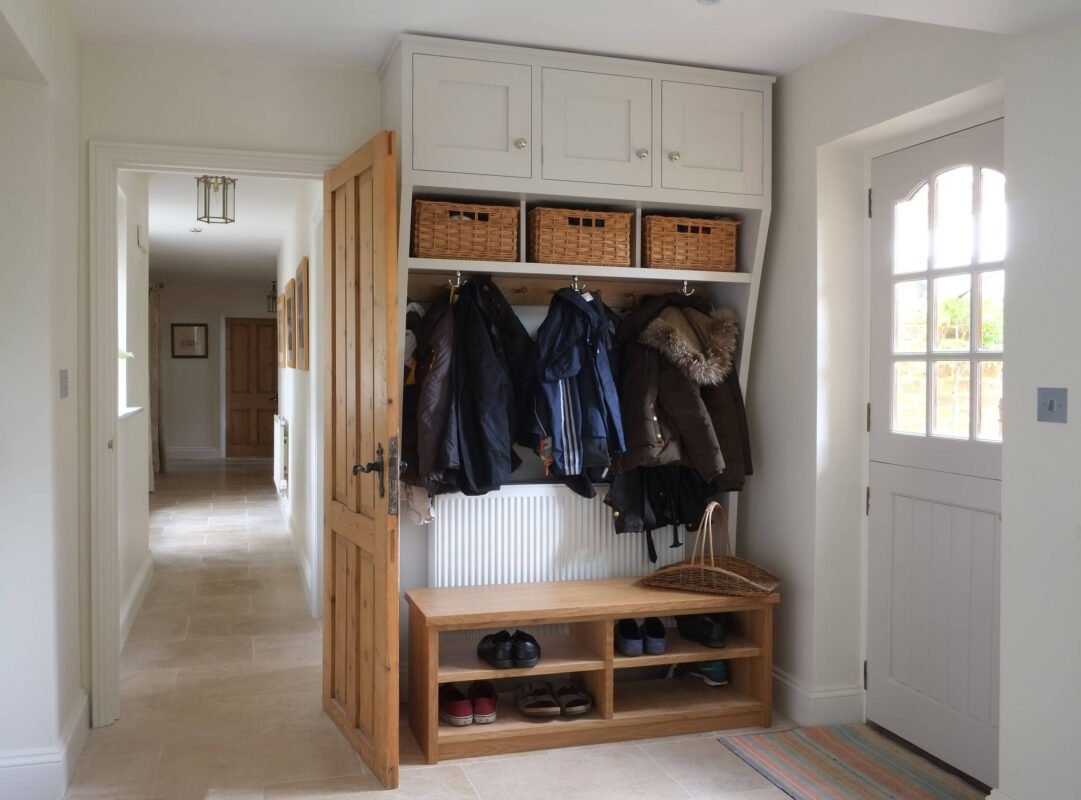Modern hallway cloakroom cupboard with coat hooks and shoe storage compartments in contemporary design